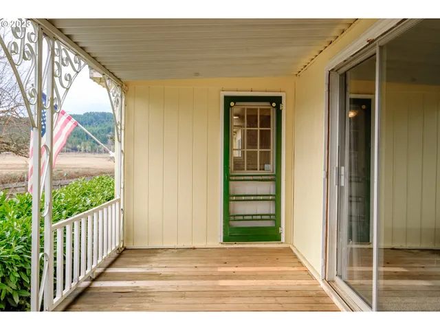a view of a house with a door and wooden floor