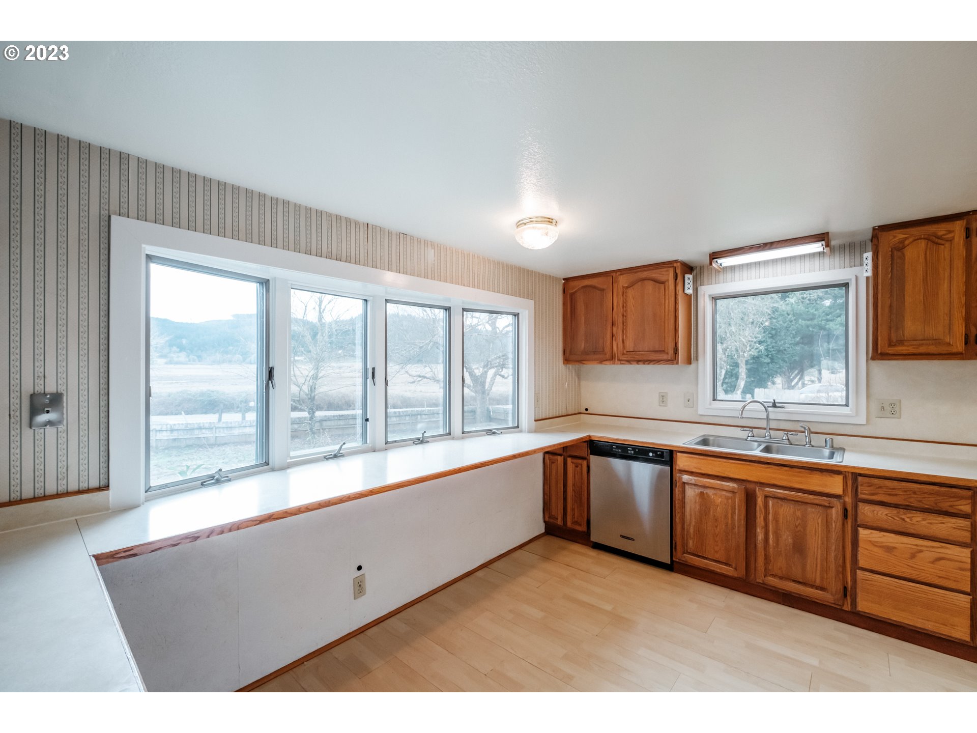 24333 Vaughn Road Veneta, OR 97487 - Photo 5 of 27 a large white kitchen with a large window