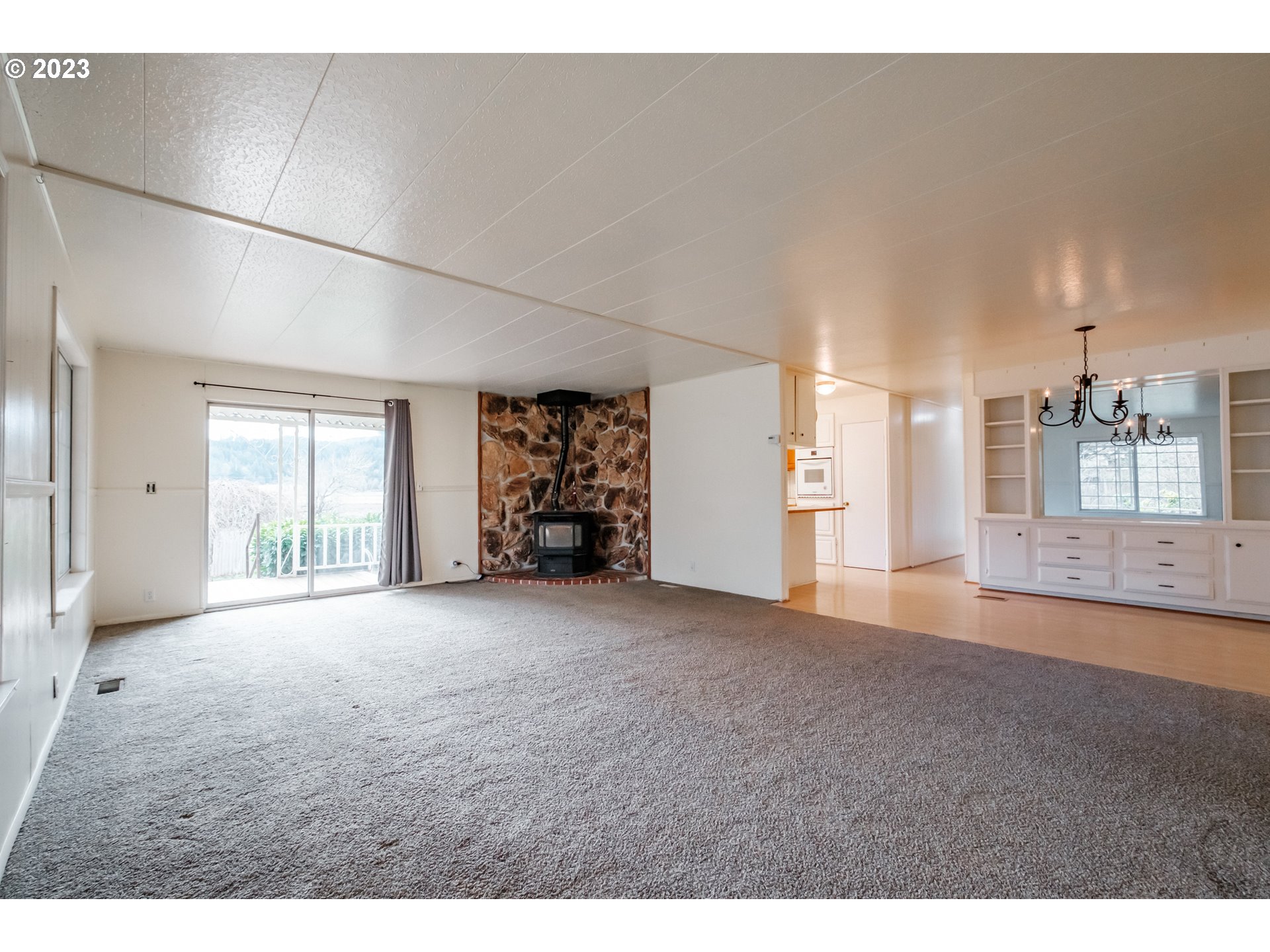 24333 Vaughn Road Veneta, OR 97487 - Photo 8 of 27 a view of a big room with windows and cabinet