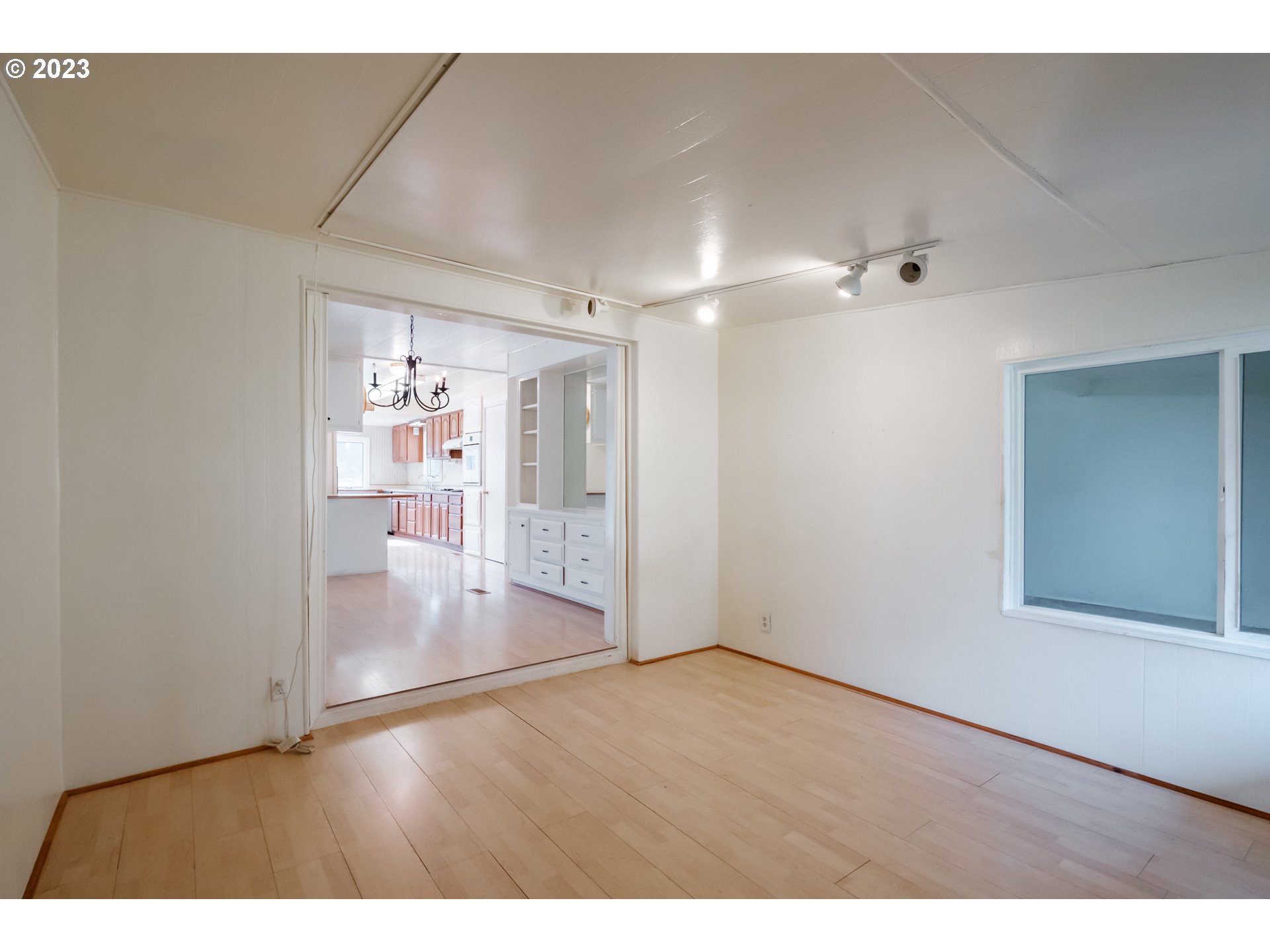 24333 Vaughn Road Veneta, OR 97487 - Photo 9 of 27 a view interior of a house wooden floor and windows in an empty room