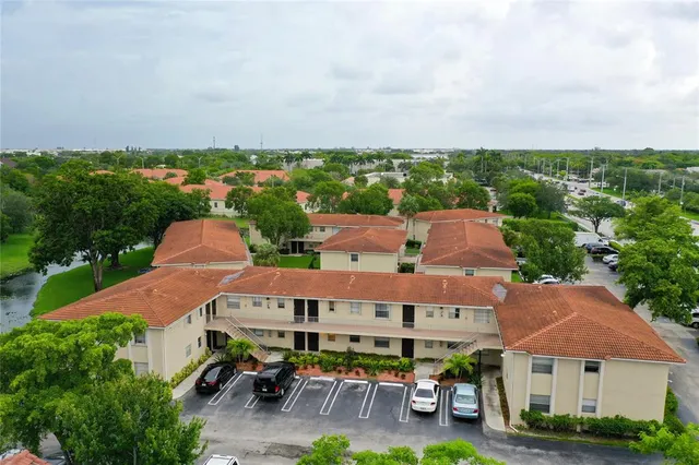 an aerial view of multiple houses with yard