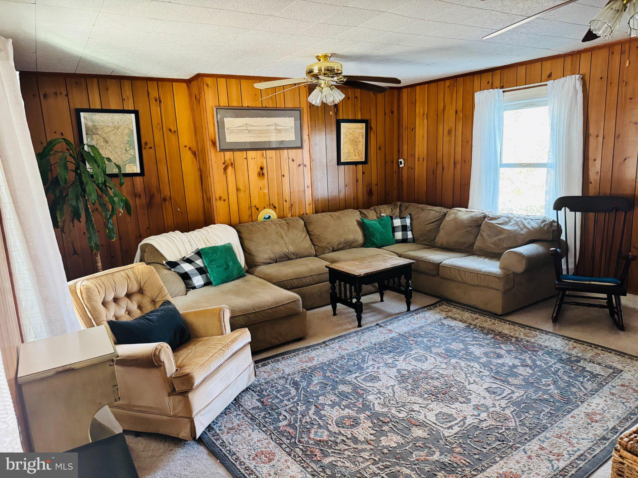 12704 Newland Road Warsaw, VA 22572 - Photo 2 of 8 Cozy living space with rustic charm.