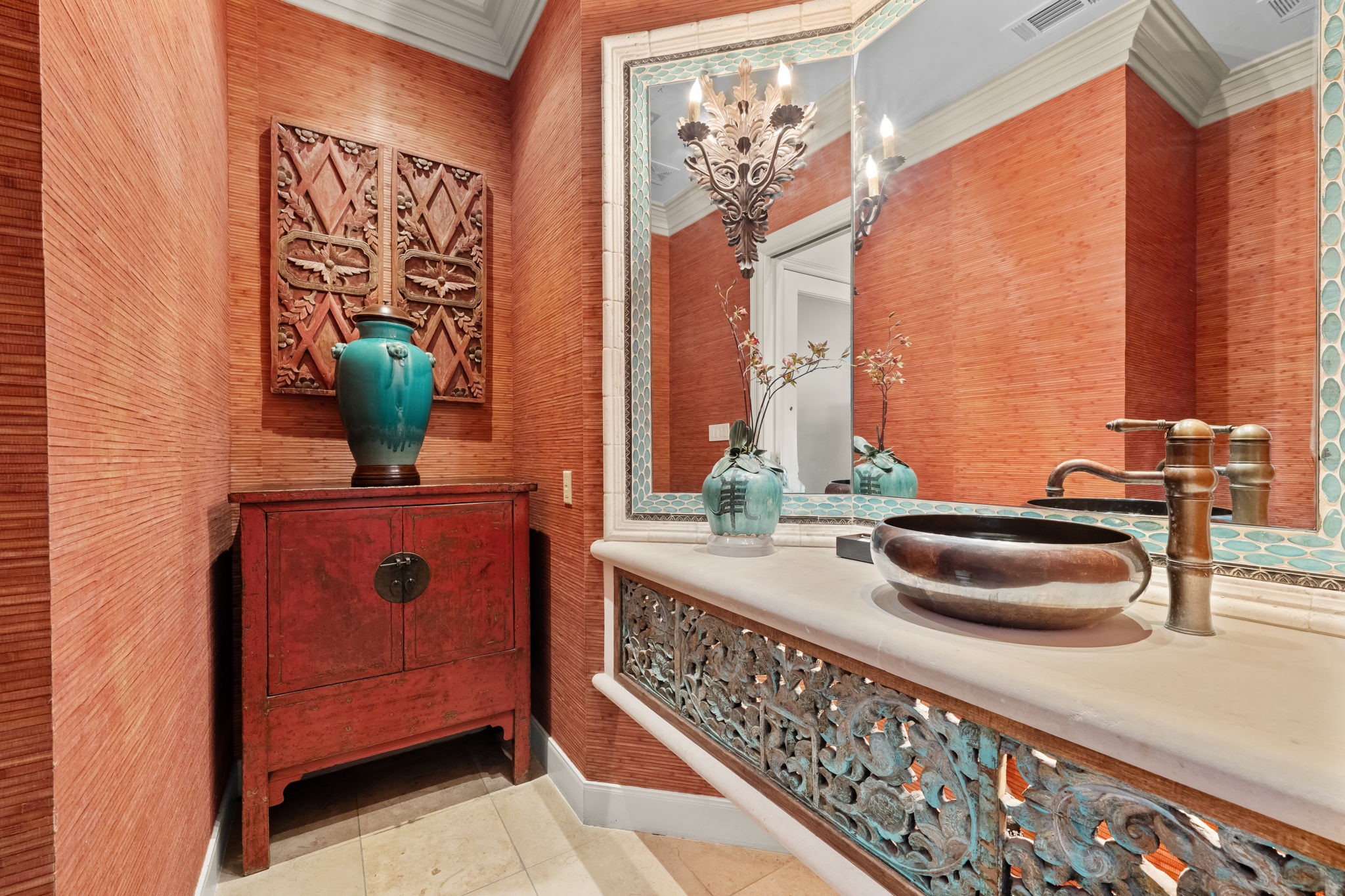 6 Mott Lane Houston, TX 77024 - Photo 34 of 50 Designer powder bath showcasing rich textured walls, a custom vanity with intricate detailing, and a statement vessel sink. Elegant finishes and artistic accents create a bold, sophisticated space.