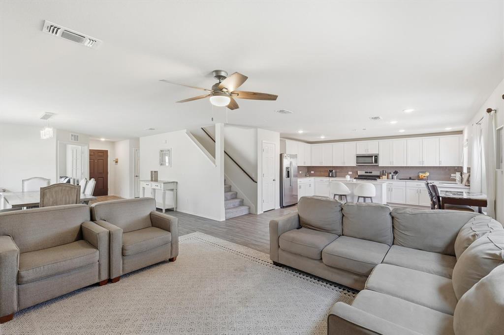 16041 Pious Drive Haslet, TX 76052 - Photo 9 of 36 Living room featuring light wood-style flooring, a ceiling fan, stairs, and recessed lighting