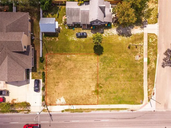 an aerial view of residential houses with yard
