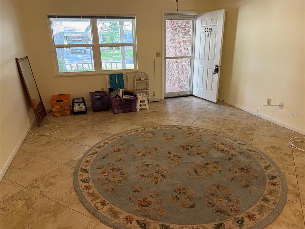 9529 Southwest 85th Avenue, Unit D Ocala, FL 34481 - Photo 4 of 21 a view of a livingroom with wooden floor and a window