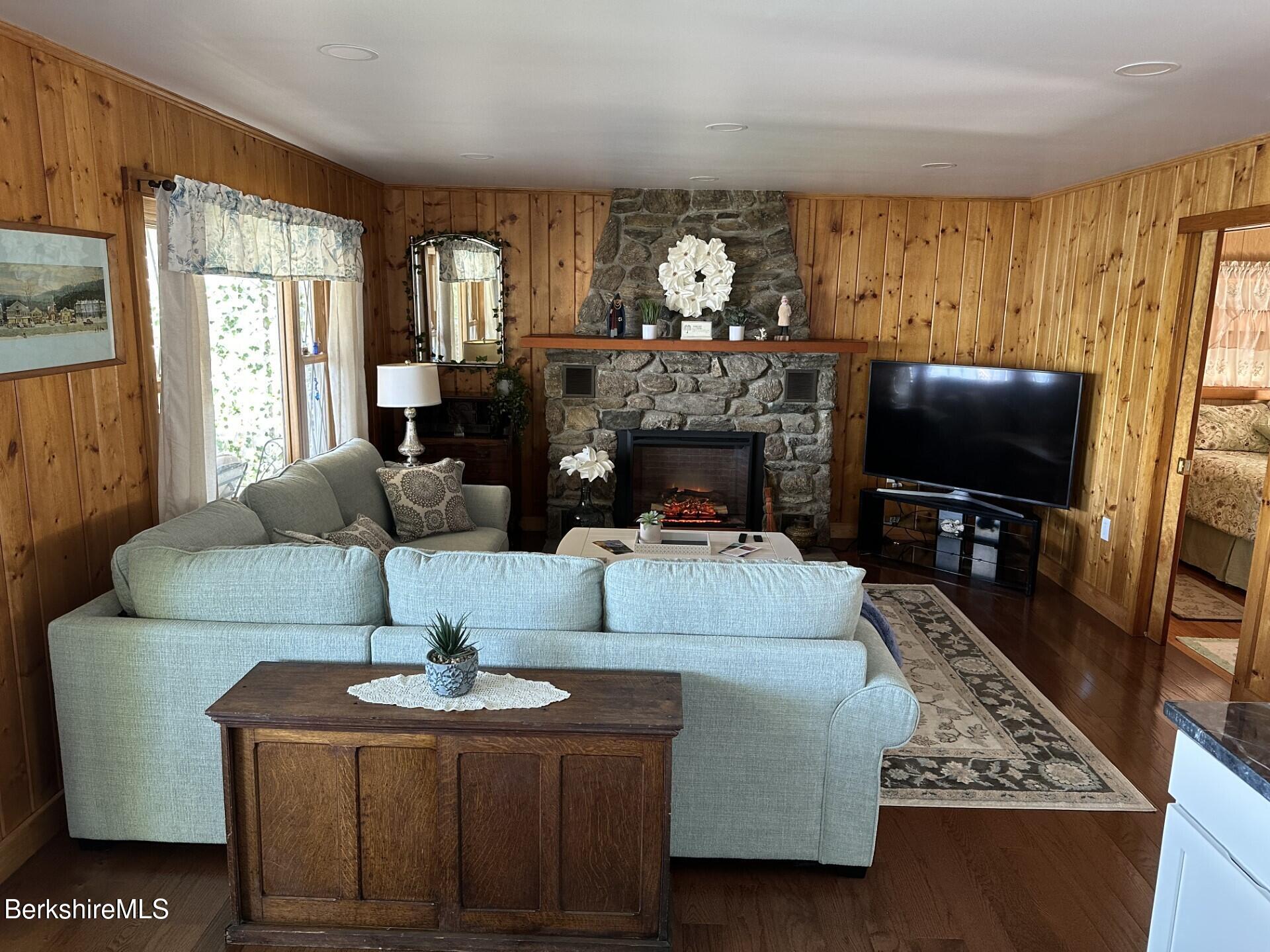 210 Shore Road Richmond, MA 01201 - Photo 16 of 22 a living room with fireplace furniture and a flat screen tv