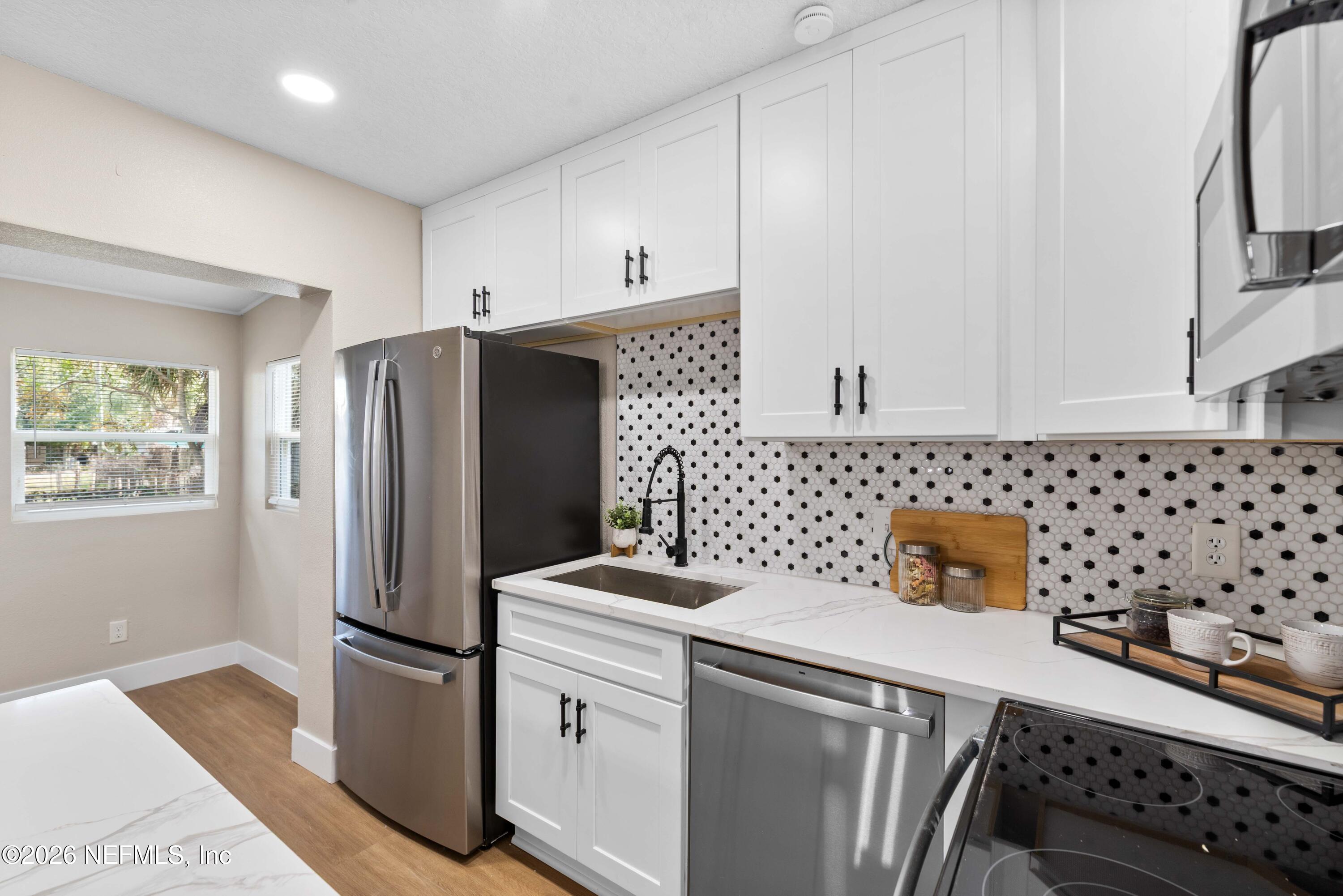 529 Sapelo Road Jacksonville, FL 32216 - Photo 14 of 31 a kitchen with stainless steel appliances a refrigerator sink and cabinets