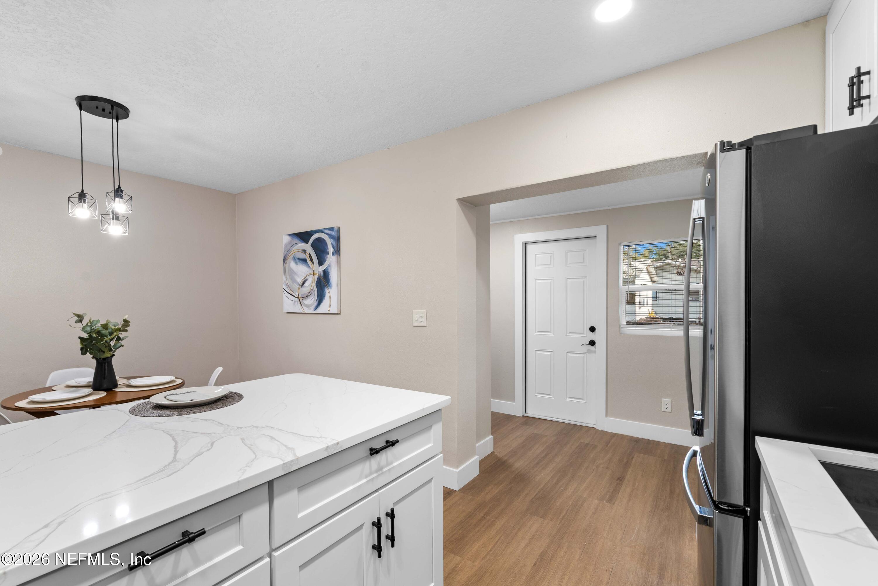 529 Sapelo Road Jacksonville, FL 32216 - Photo 15 of 31 a kitchen with a sink cabinets and wooden floor