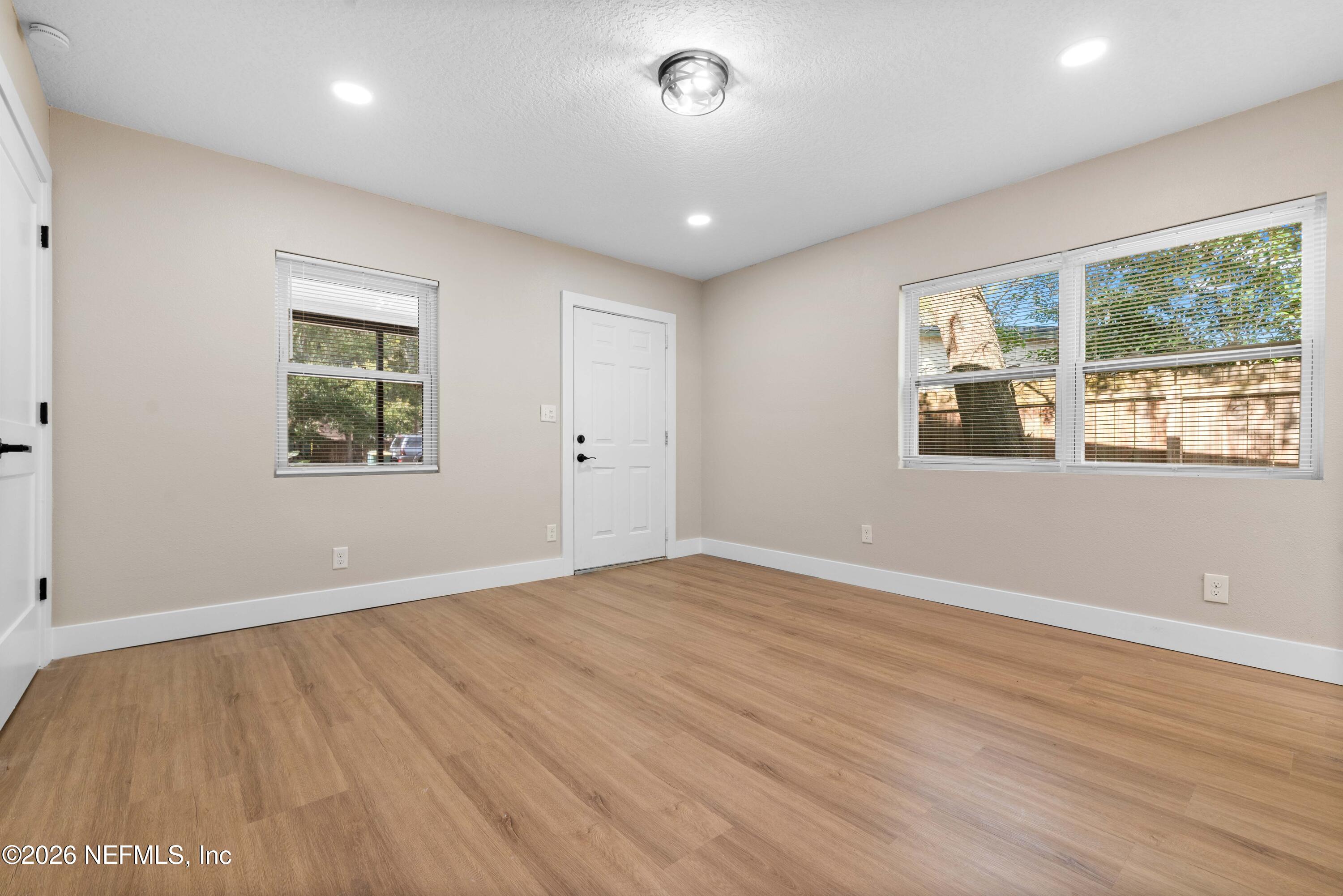 529 Sapelo Road Jacksonville, FL 32216 - Photo 17 of 31 a view of an empty room with wooden floor and a window