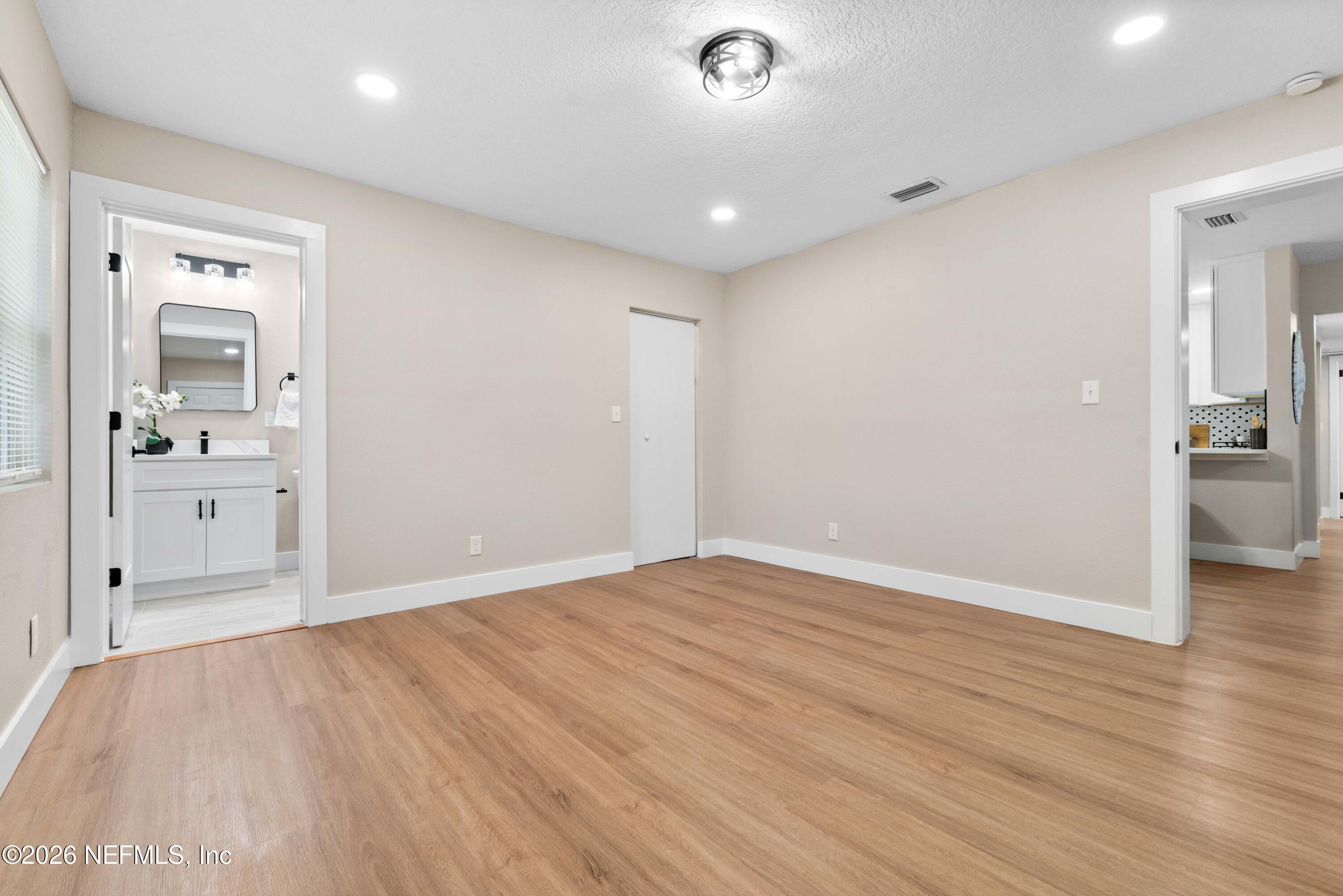 529 Sapelo Road Jacksonville, FL 32216 - Photo 18 of 31 wooden floor in an empty room with a window