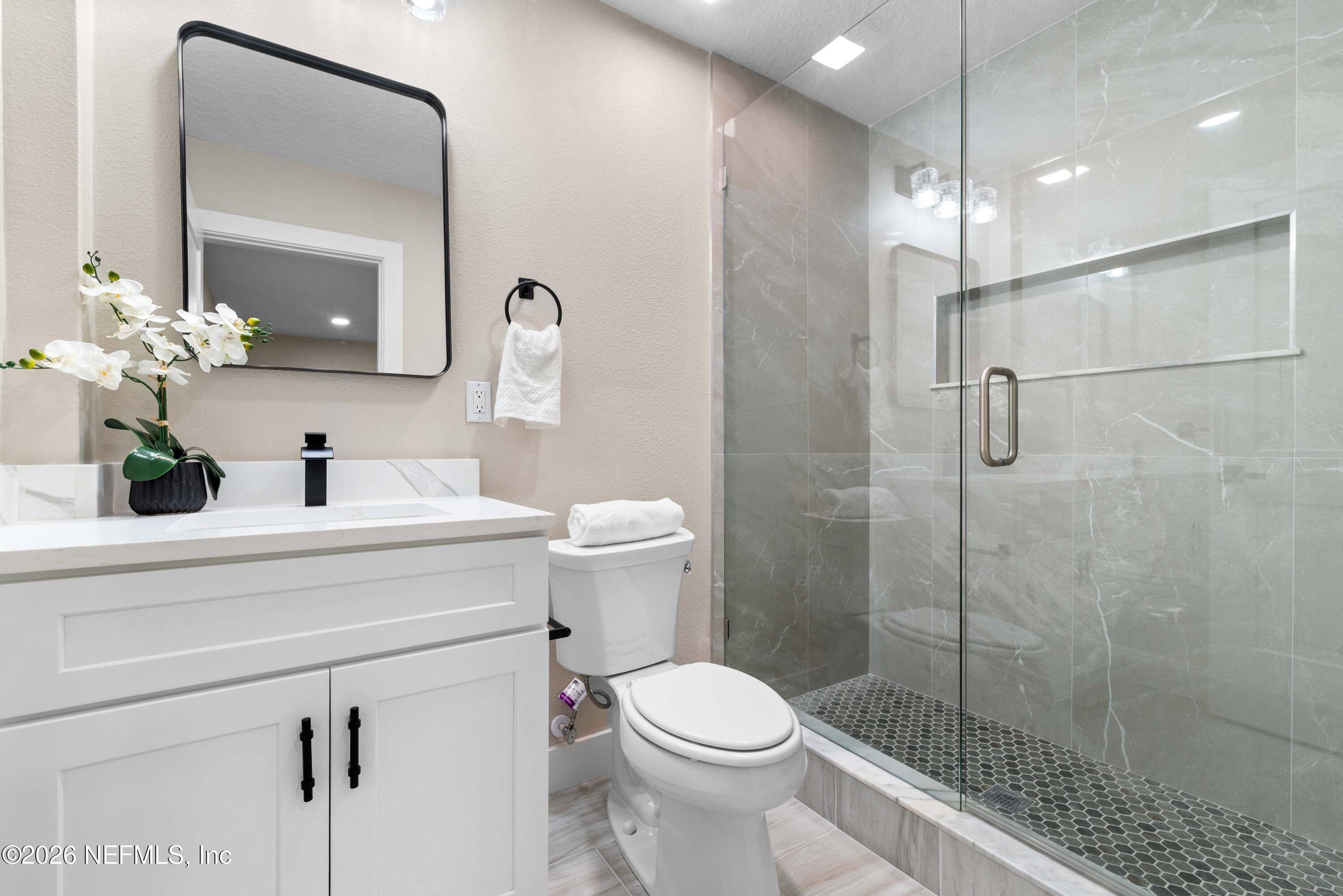 529 Sapelo Road Jacksonville, FL 32216 - Photo 19 of 31 a bathroom with a sink a toilet and shower