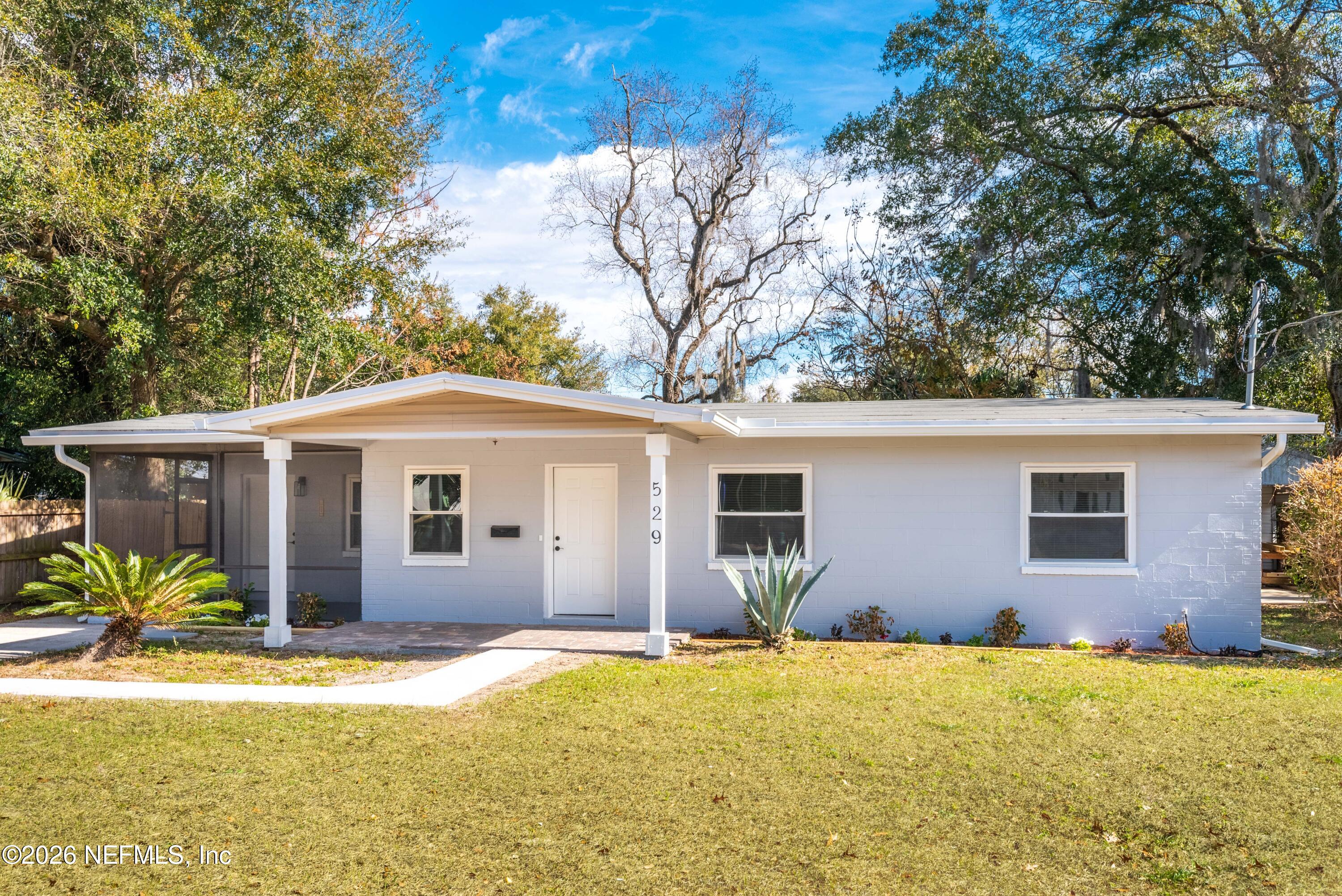 529 Sapelo Road Jacksonville, FL 32216 - Photo 2 of 31 a front view of house with yard and trees in the background