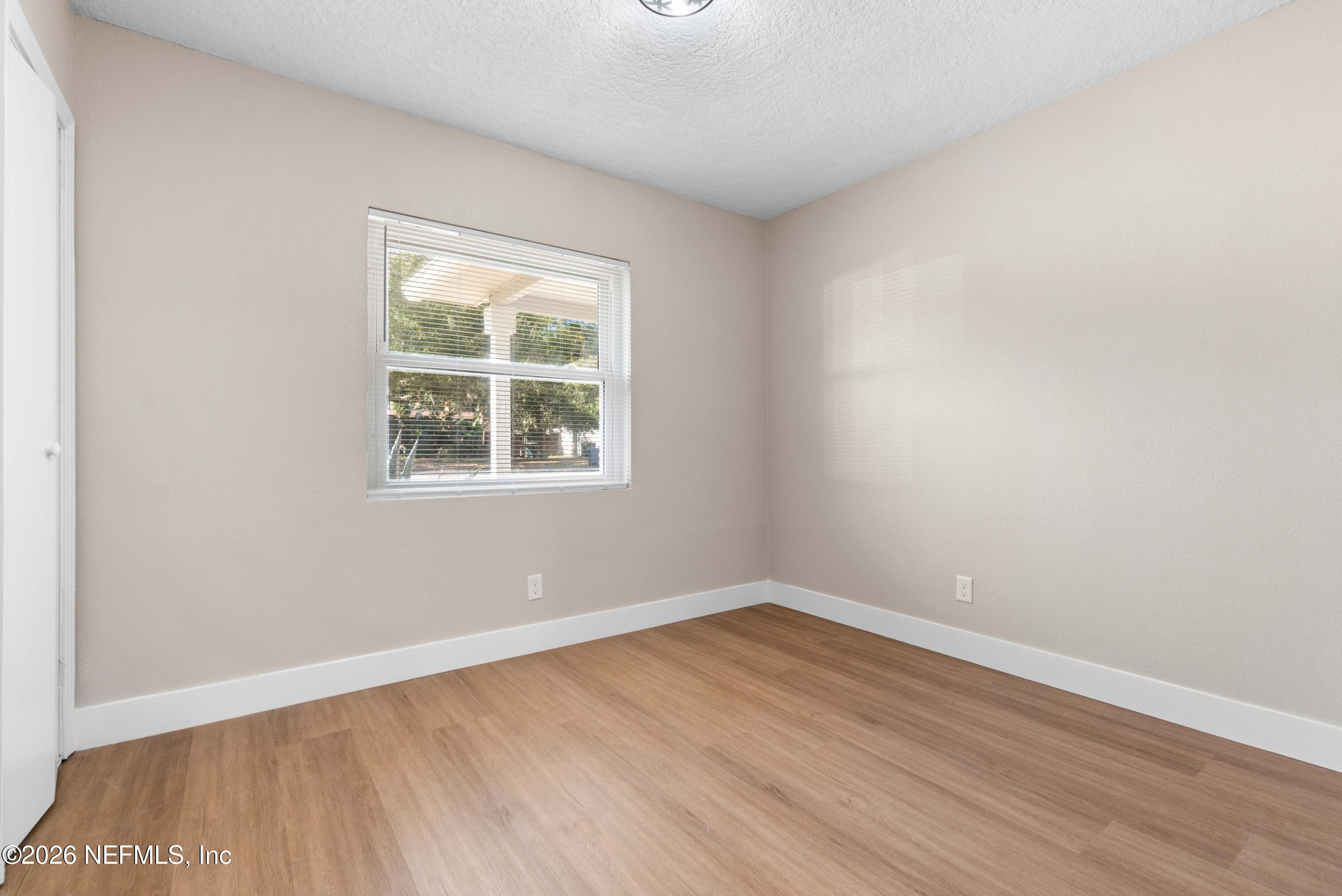 529 Sapelo Road Jacksonville, FL 32216 - Photo 24 of 31 wooden floor in an empty room with a window