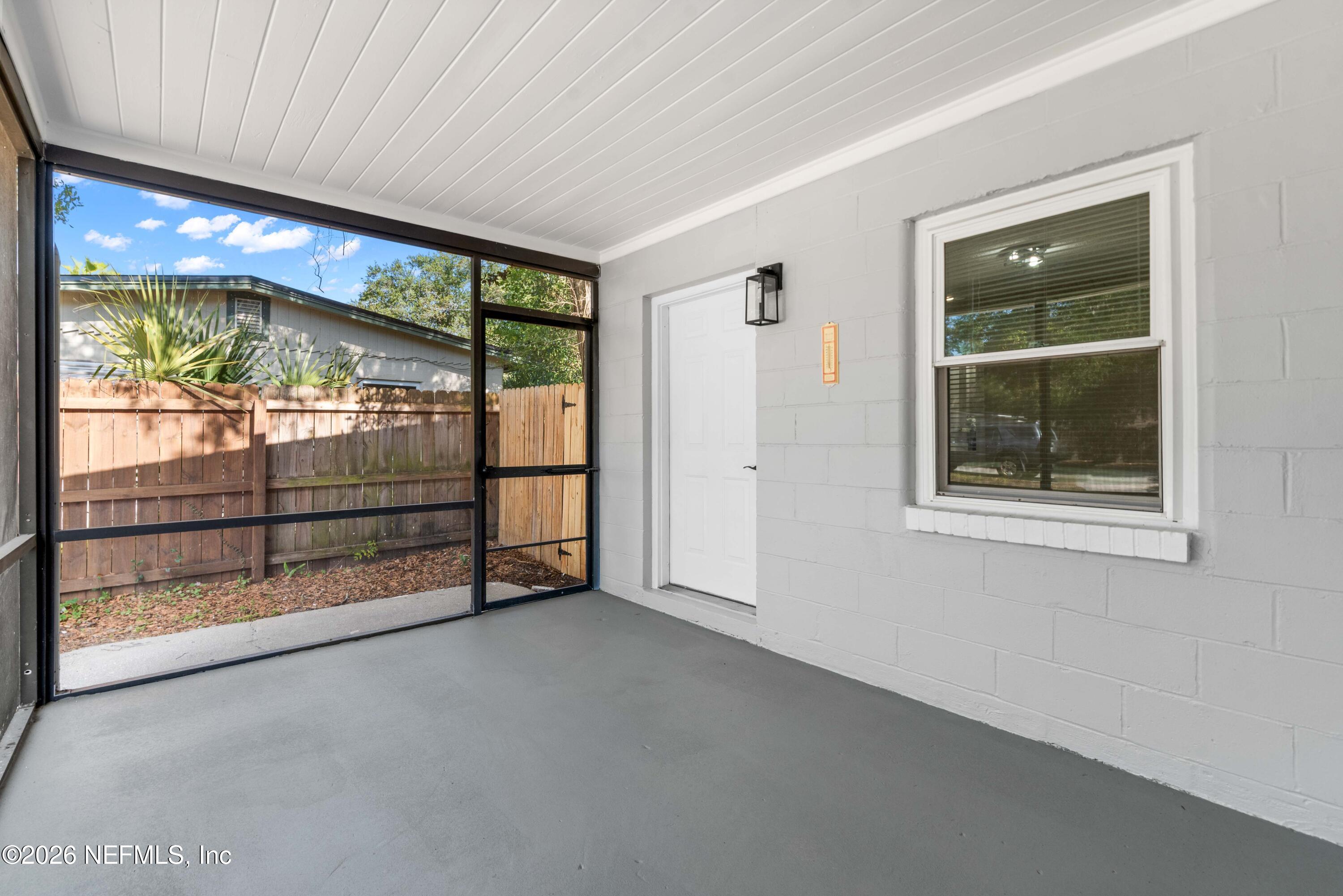 529 Sapelo Road Jacksonville, FL 32216 - Photo 25 of 31 an empty room with sliding door and wooden floor
