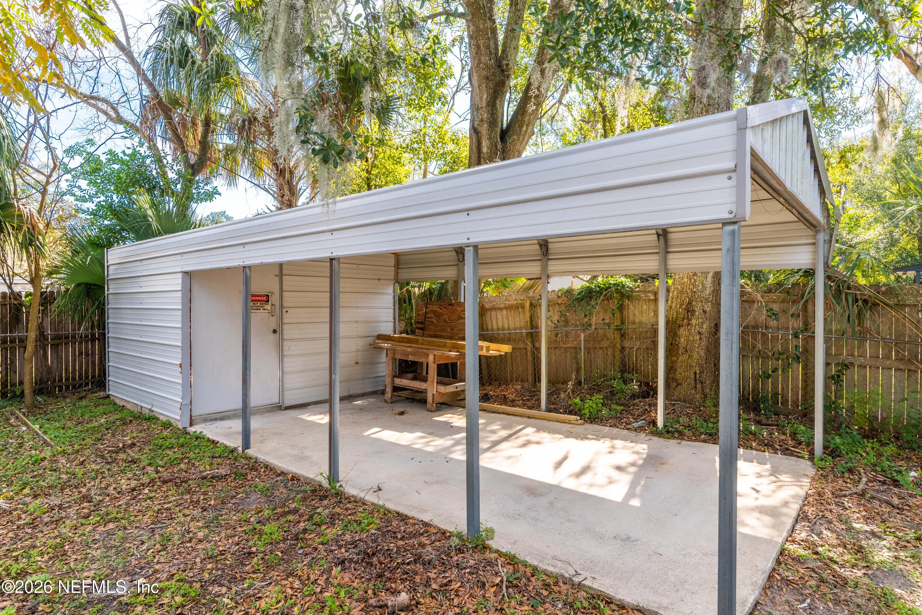 529 Sapelo Road Jacksonville, FL 32216 - Photo 30 of 31 a view of a patio with a table and chairs and floor to ceiling window