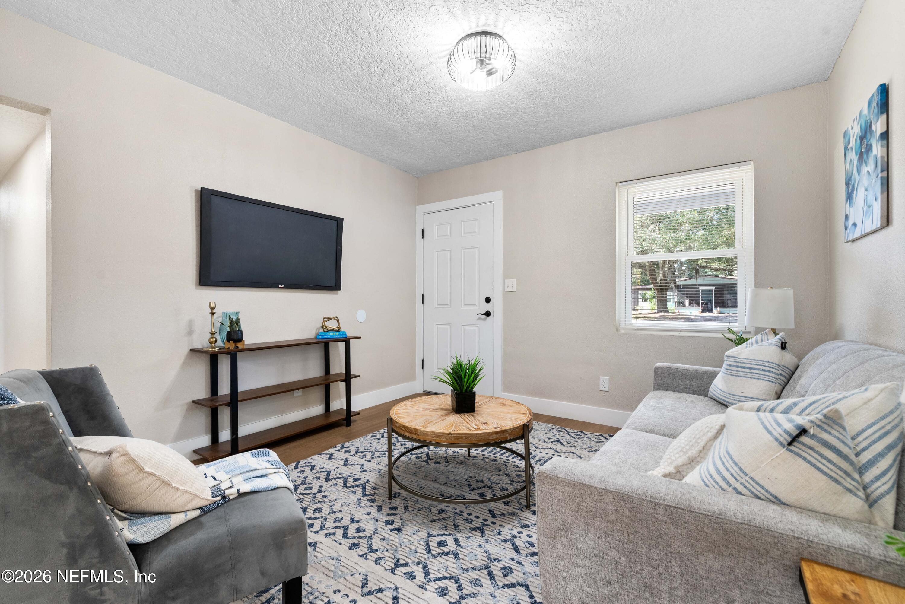 529 Sapelo Road Jacksonville, FL 32216 - Photo 6 of 31 a living room with furniture a window and a flat screen tv