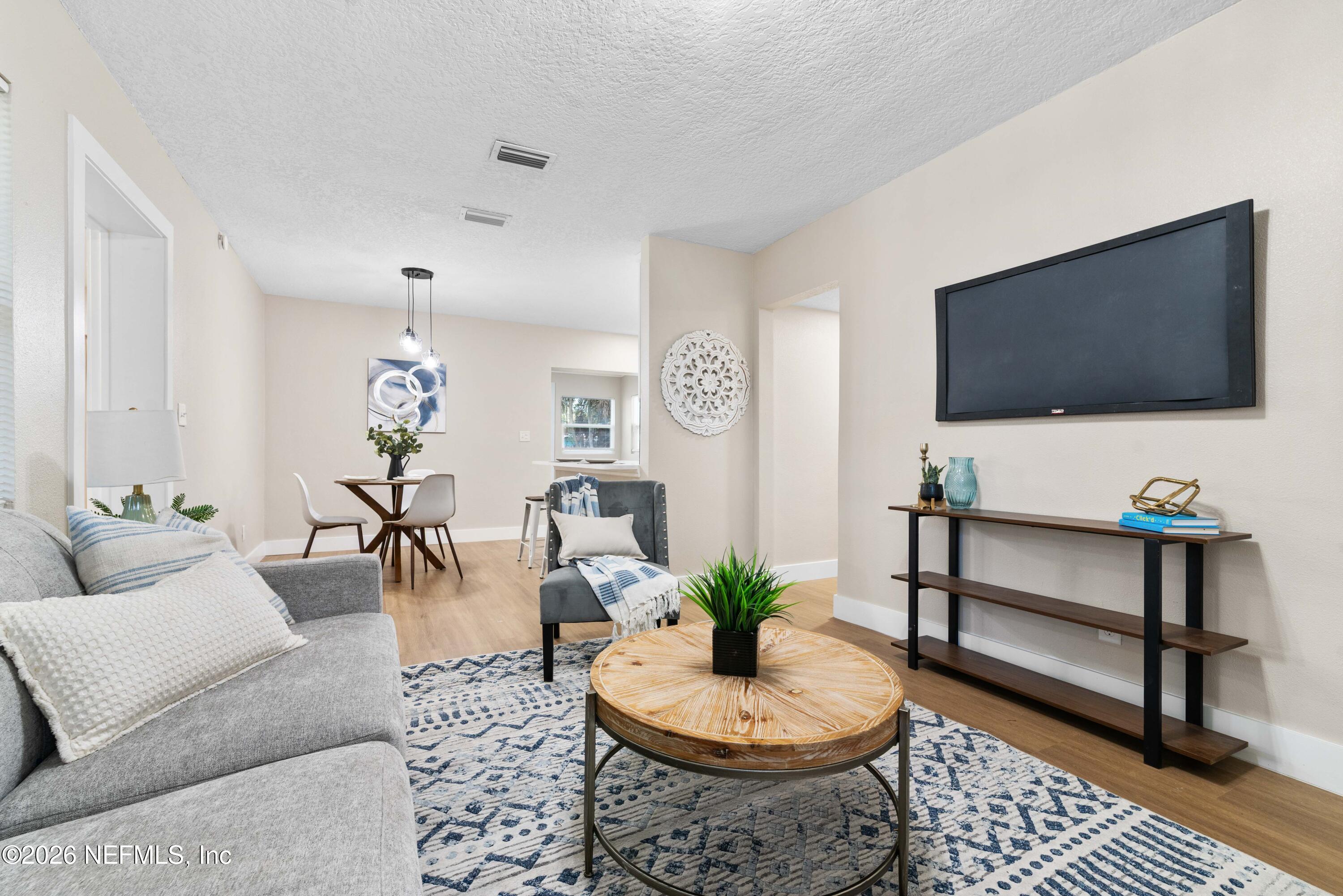 529 Sapelo Road Jacksonville, FL 32216 - Photo 9 of 31 a living room with furniture and a flat screen tv