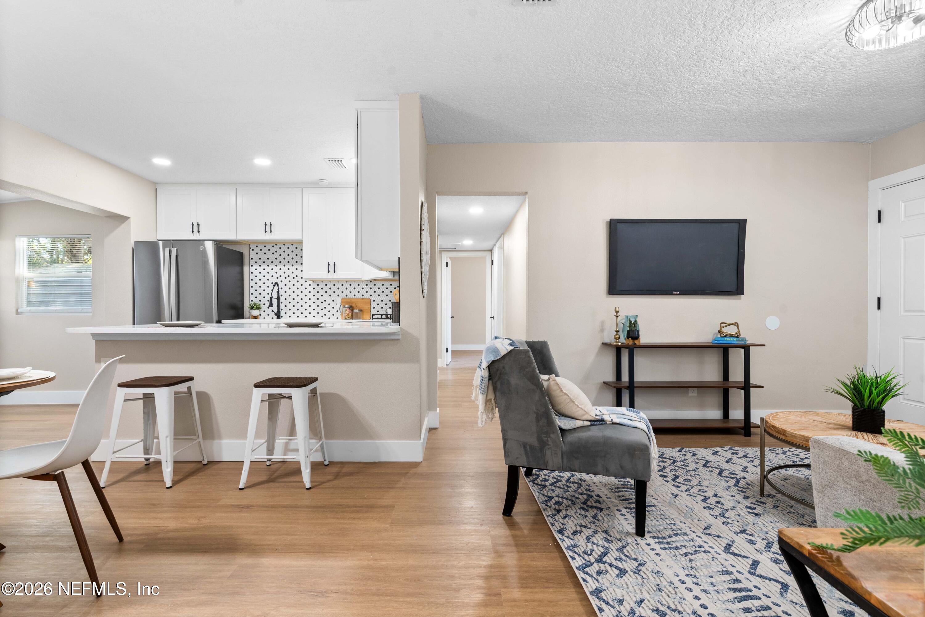 529 Sapelo Road Jacksonville, FL 32216 - Photo 10 of 31 a living room with furniture and a flat screen tv