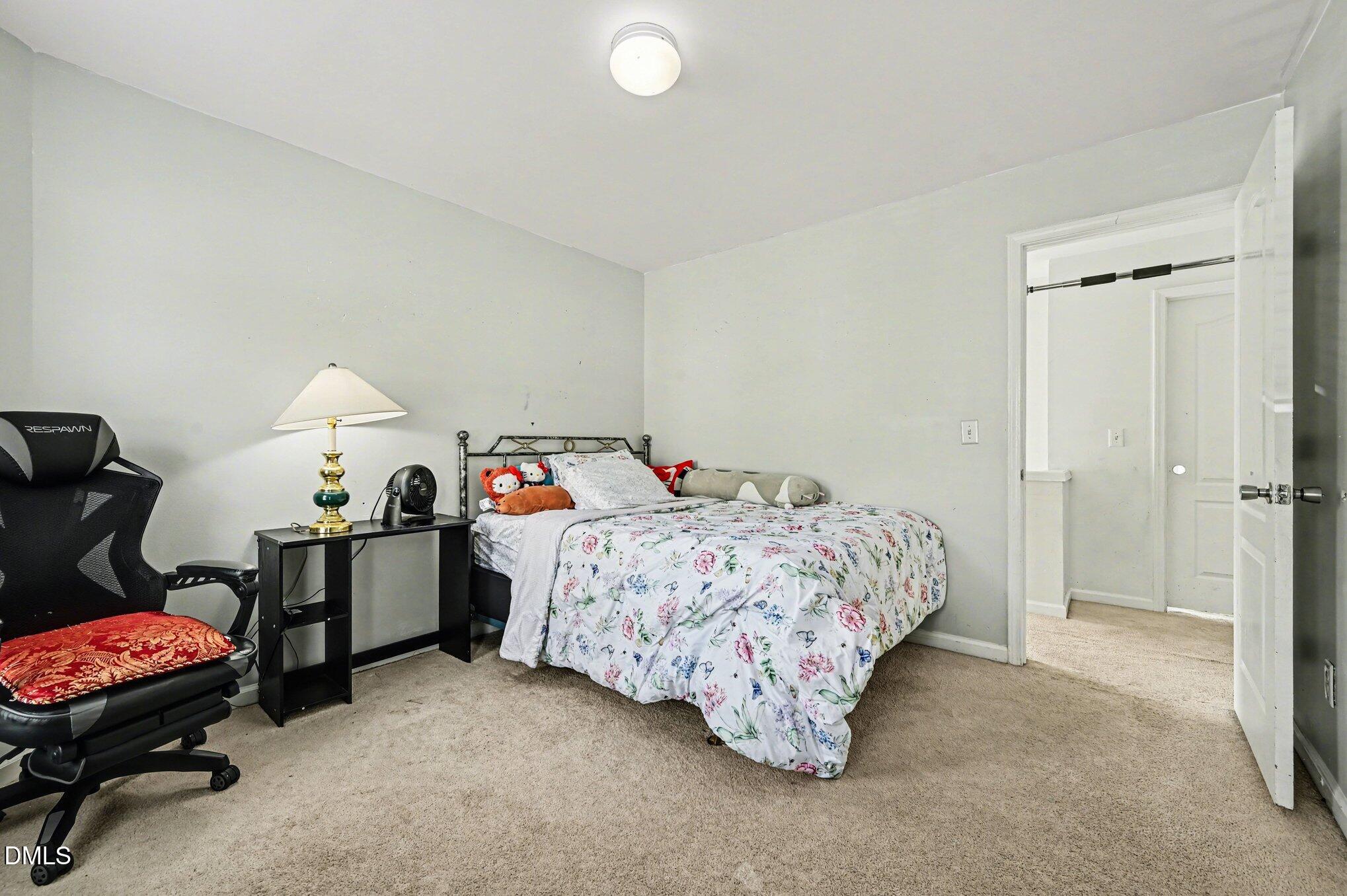 5115 Cardinal Grove Boulevard Raleigh, NC 27616 - Photo 14 of 36 a bed room with a bed and a chair