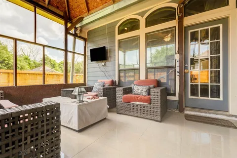 a bedroom with furniture and large windows