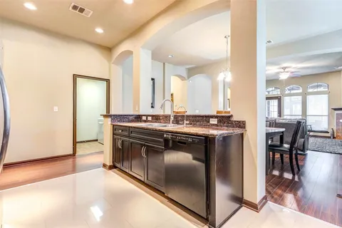 a kitchen with stainless steel appliances granite countertop a stove and a sink