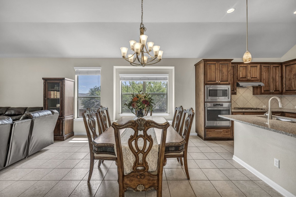 3821 Tordera Drive Austin, TX 78738 - Photo 12 of 30 a view of a dining room with furniture a chandelier and window
