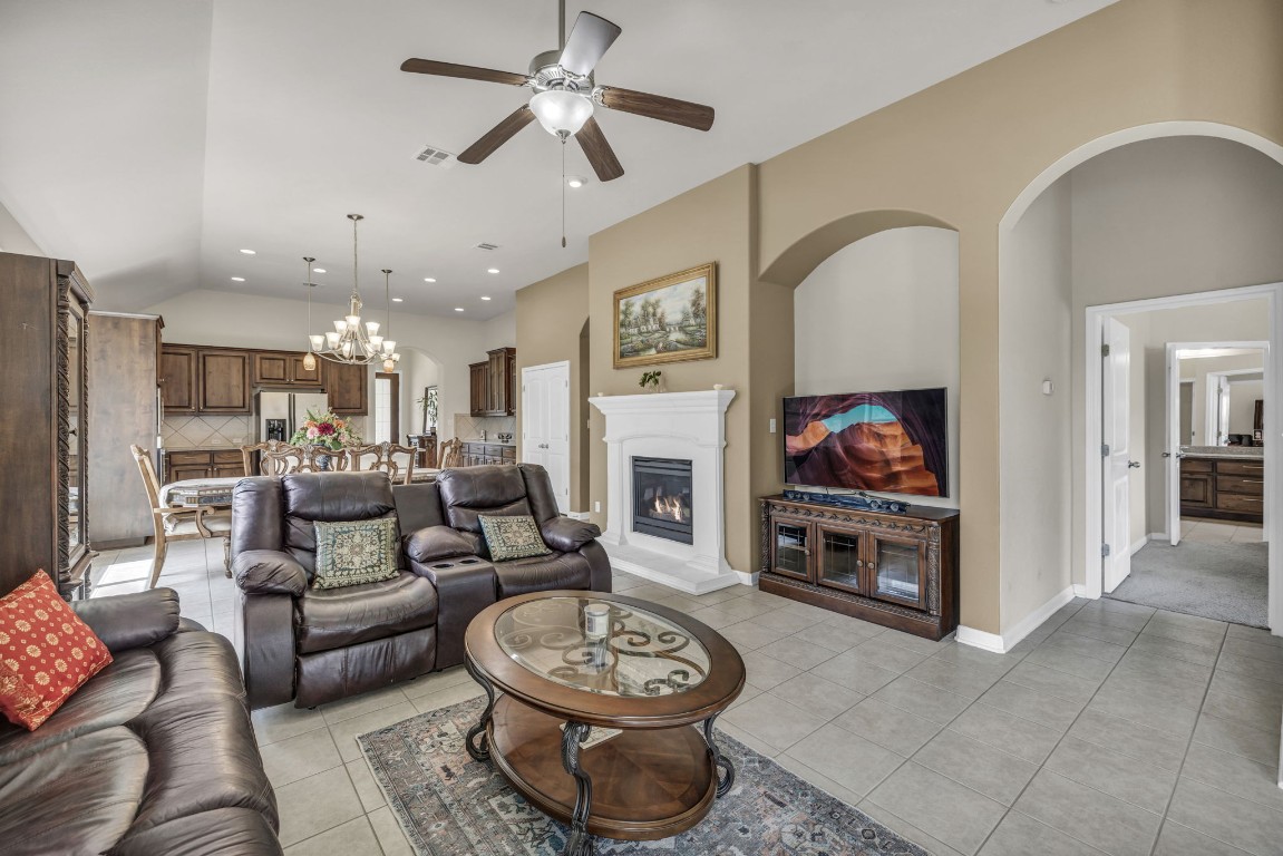 3821 Tordera Drive Austin, TX 78738 - Photo 15 of 30 a living room with furniture a fireplace and a flat screen tv
