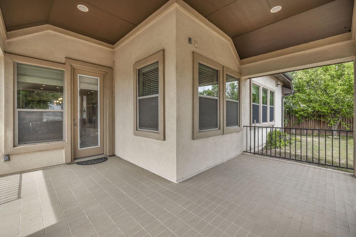 3821 Tordera Drive Austin, TX 78738 - Photo 28 of 30 a view of a porch with a floor to ceiling window and wooden fence