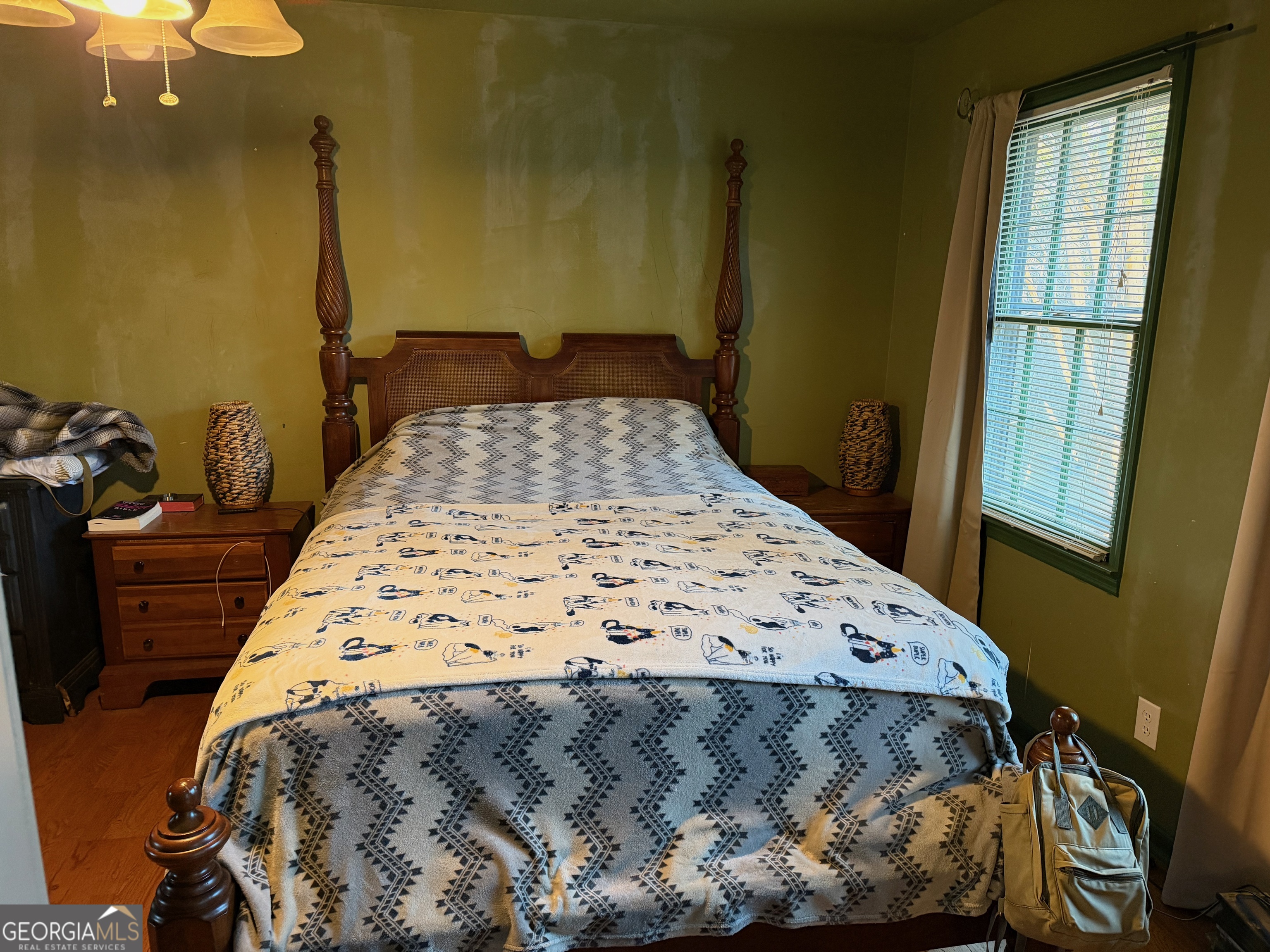 710 Armstrong Mill Road Franklin, GA 30217 - Photo 10 of 19 a bed sitting in a bedroom next to a window