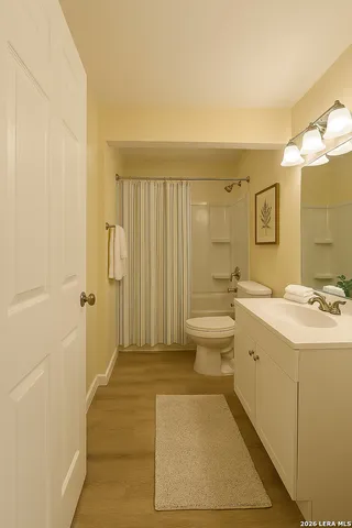 a spacious bathroom with a sink a toilet and shower