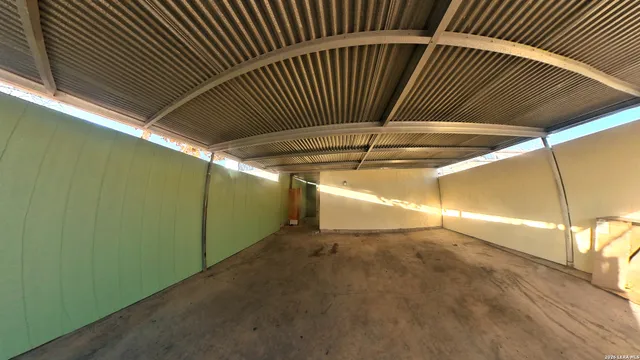 a living room with furniture a flat screen tv and a table