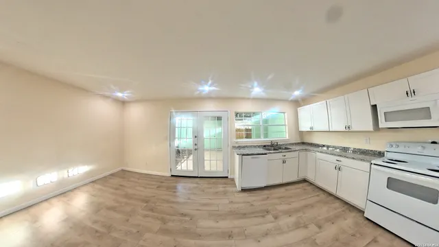 a kitchen with a sink stove and cabinets