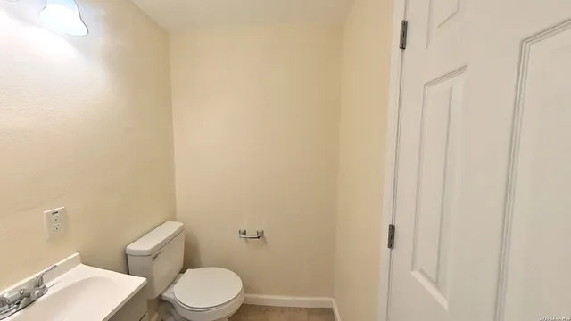 a white toilet sitting next to a shower