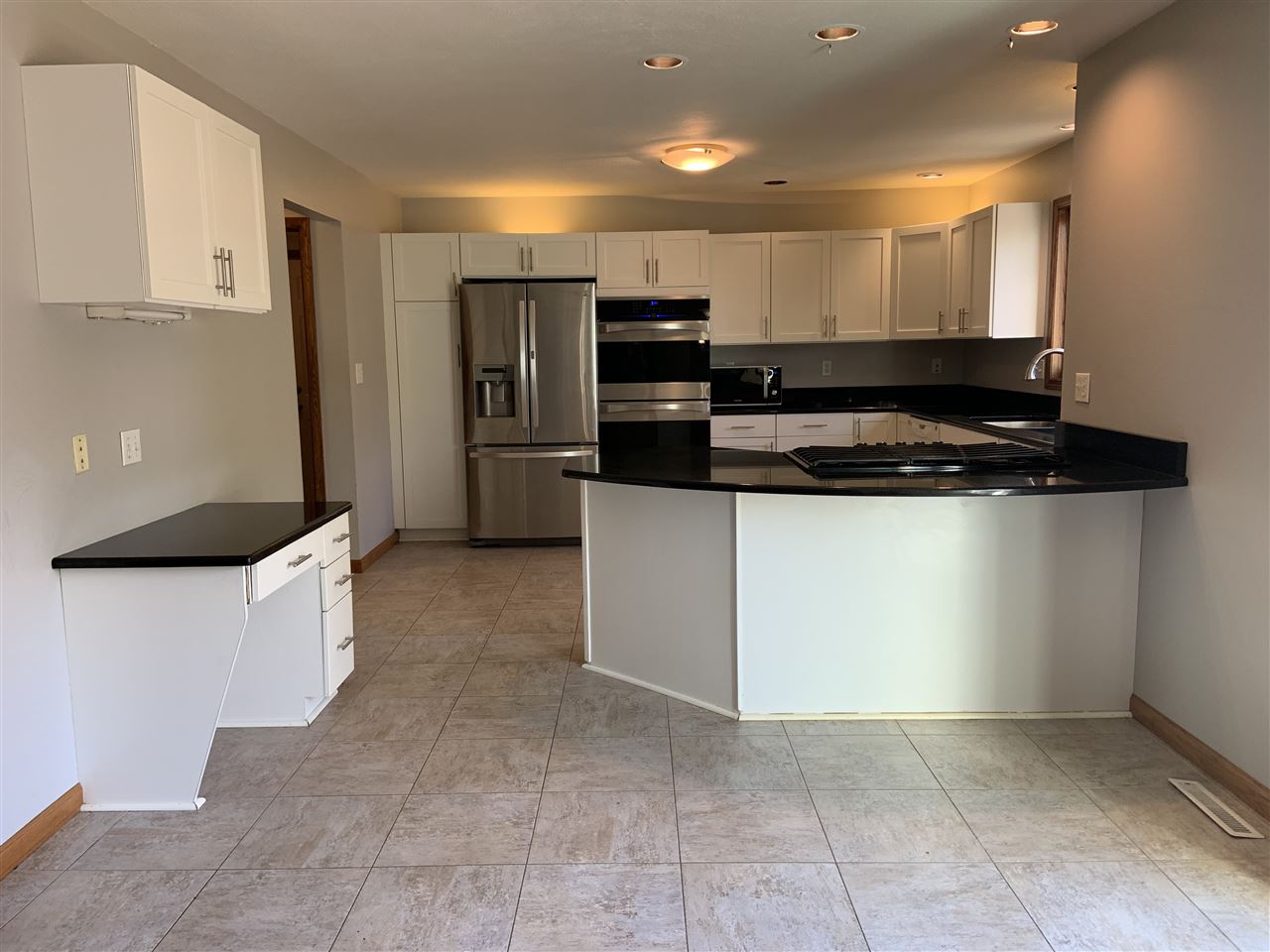 6912 Sentinel Road Rockford, IL 61107 - Photo 11 of 27 a kitchen with stainless steel appliances granite countertop a stove a sink and a refrigerator