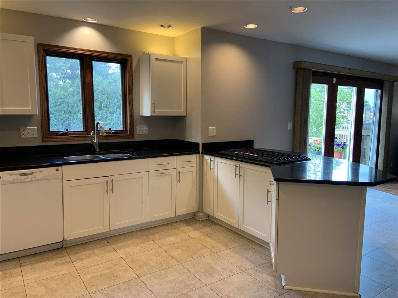 6912 Sentinel Road Rockford, IL 61107 - Photo 13 of 27 a kitchen with granite countertop a sink and white cabinets