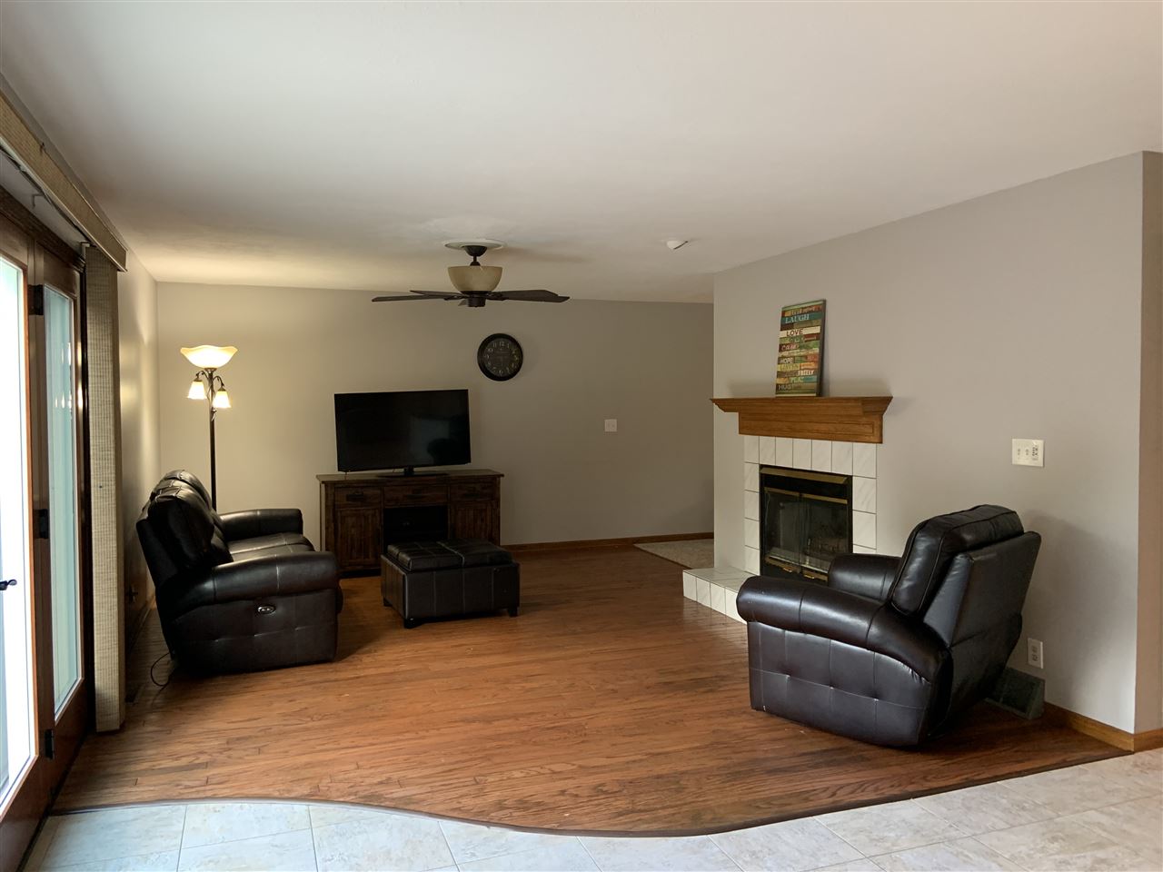 6912 Sentinel Road Rockford, IL 61107 - Photo 15 of 27 a living room with furniture a fireplace and a flat screen tv