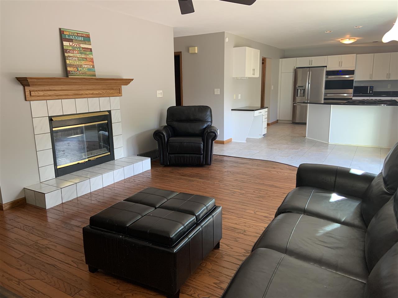 6912 Sentinel Road Rockford, IL 61107 - Photo 17 of 27 a living room with furniture and a fireplace