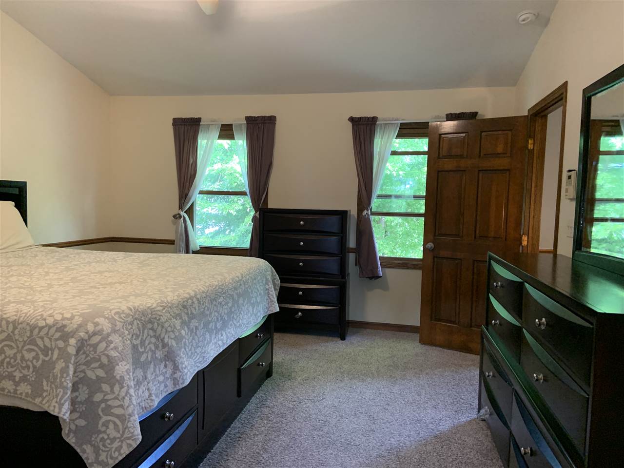 6912 Sentinel Road Rockford, IL 61107 - Photo 19 of 27 a bed sitting in a bedroom next to a window
