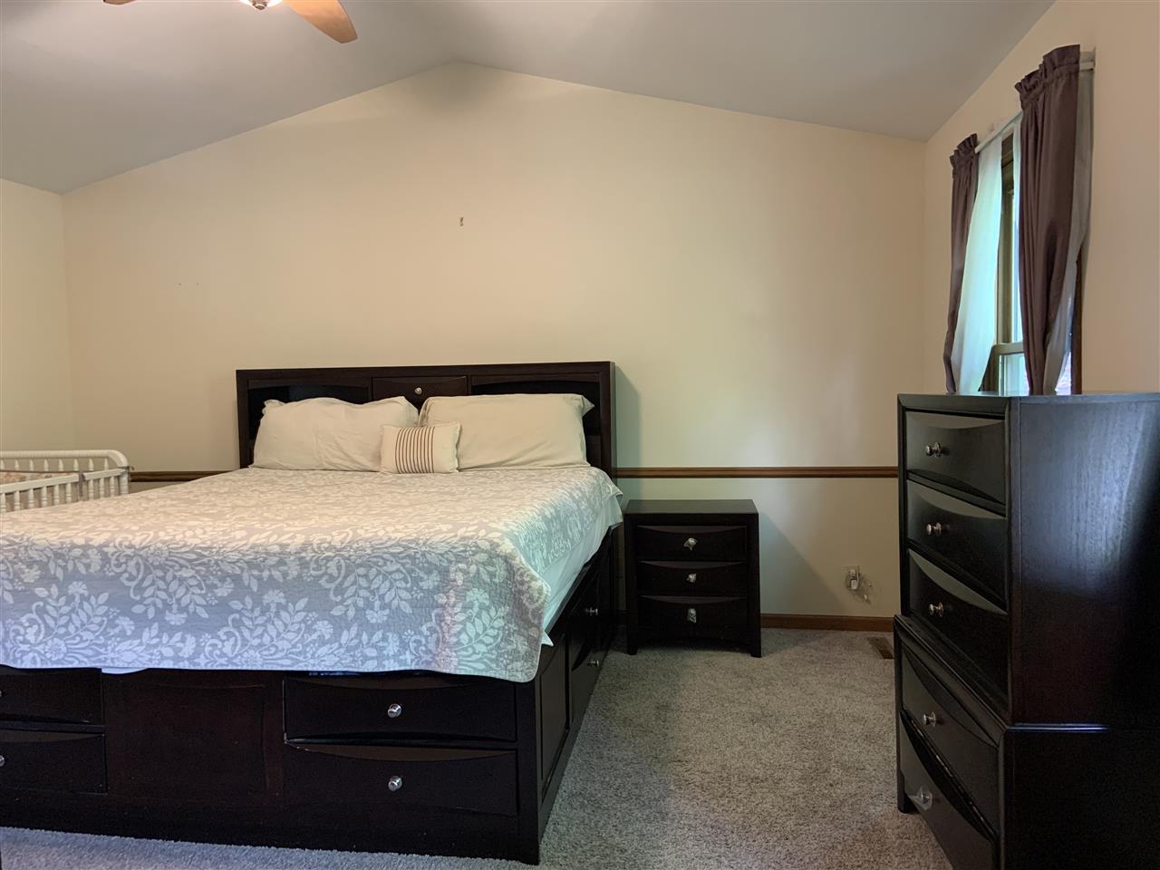 6912 Sentinel Road Rockford, IL 61107 - Photo 20 of 27 a bedroom with a bed and dresser