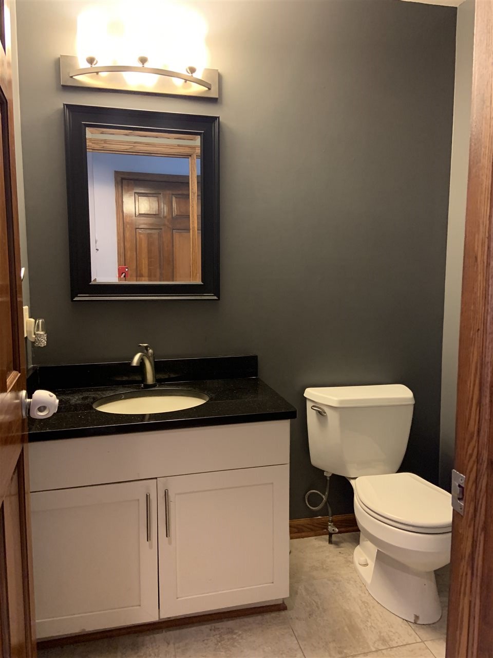 6912 Sentinel Road Rockford, IL 61107 - Photo 10 of 27 a bathroom with a toilet sink and mirror