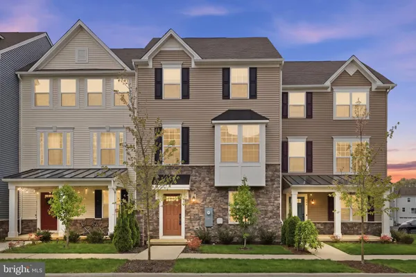 a front view of a residential apartment building with yard