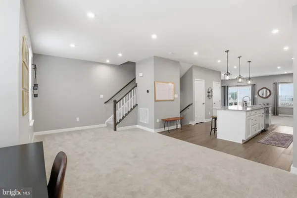 a living room with kitchen island furniture and a wooden floor