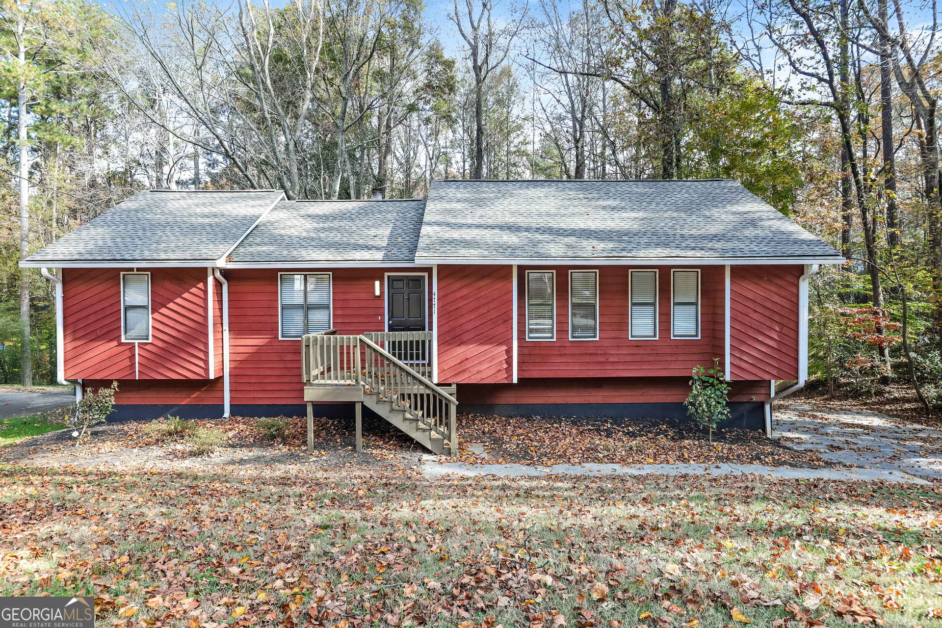 a view of a house with a yard and hanging chair