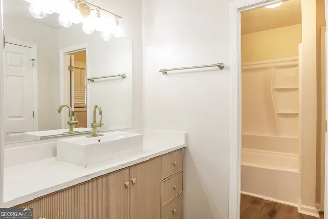 a bathroom with a sink and a mirror
