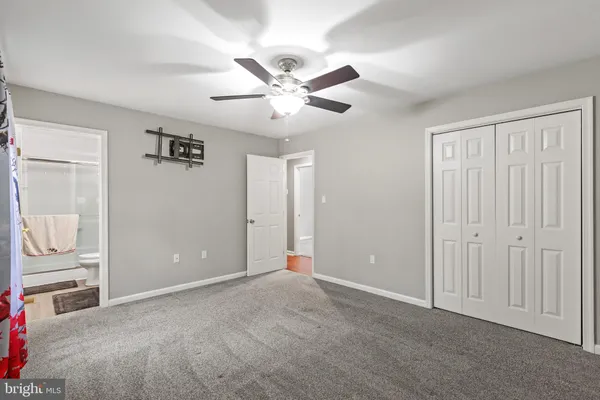 an empty room with closet and windows