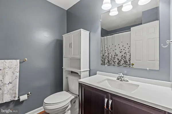 a bathroom with a sink toilet vanity and shower