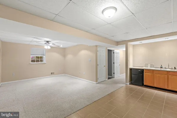 a view of a kitchen with a sink dishwasher stove and refrigerator