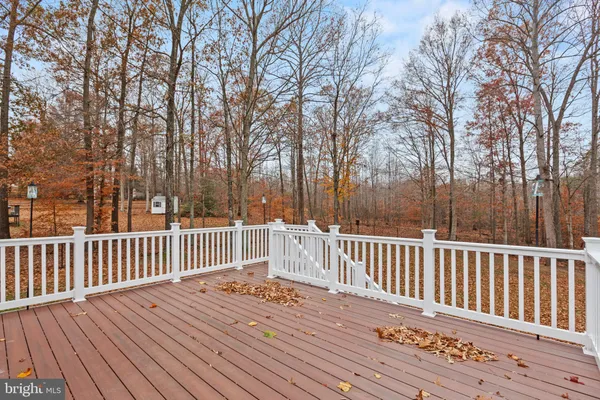a view of backyard with deck and wooden floor