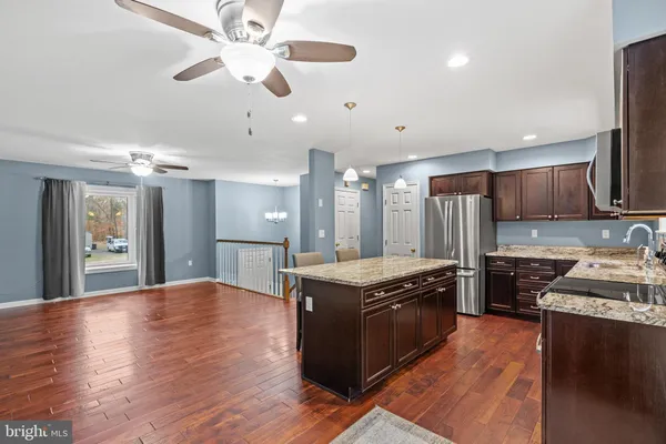 a kitchen with stainless steel appliances granite countertop a stove and a refrigerator